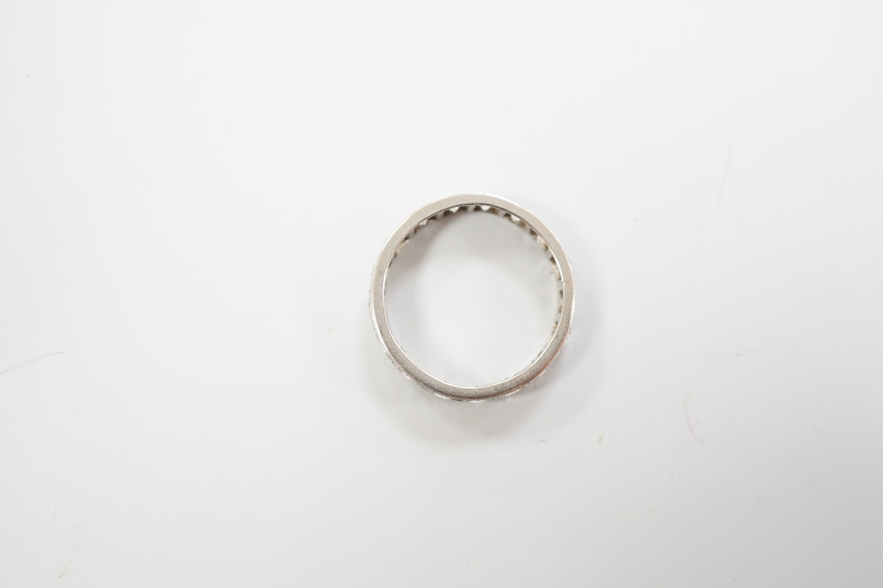 A white metal and diamond set full eternity ring, size M, gross weight 3.9 grams.